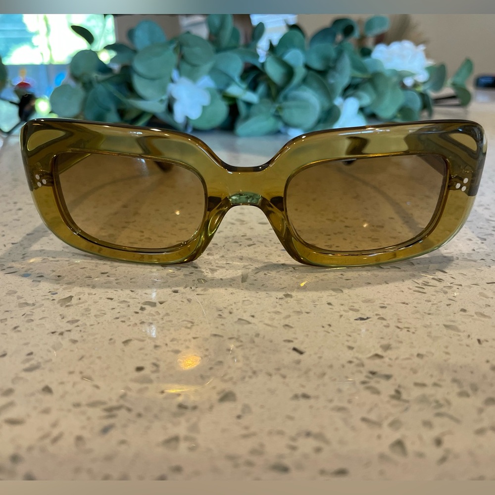 Saurine dark honey colored sunglasses from Oliver Peoples